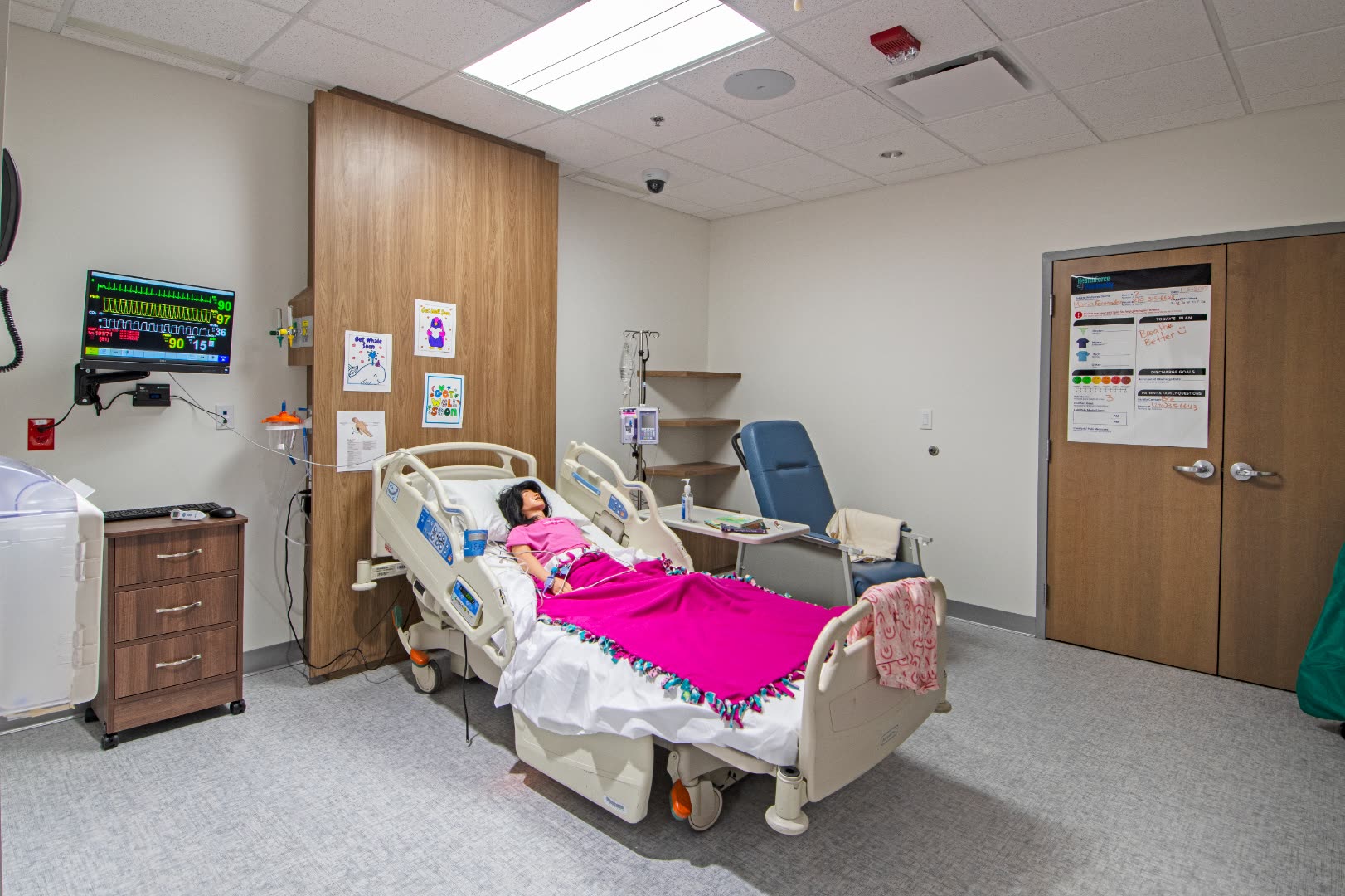 High-fidelity patient simulation room with mannequin and vitals monitor