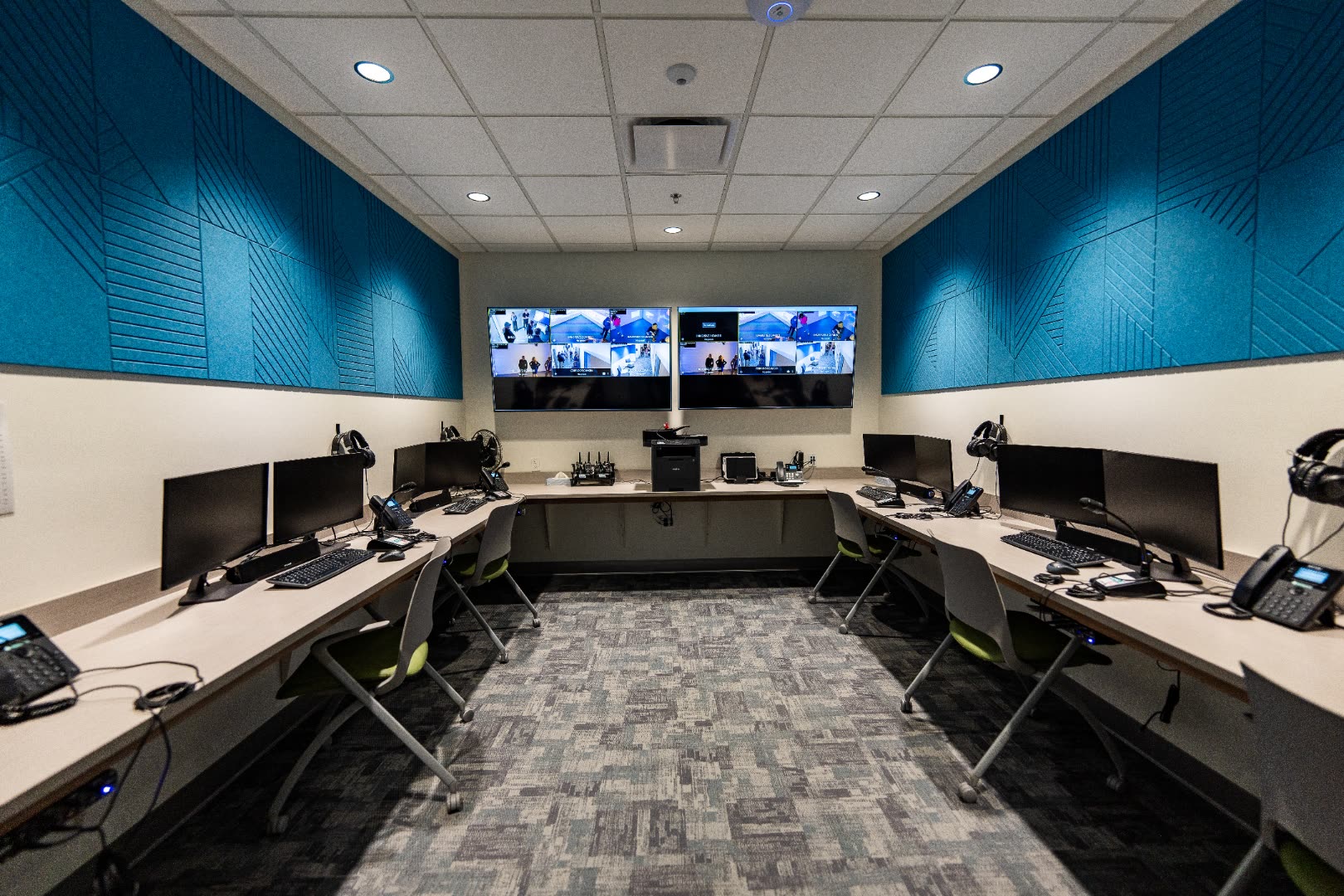 SimStation control room with rows of monitors and acoustic-paneled walls